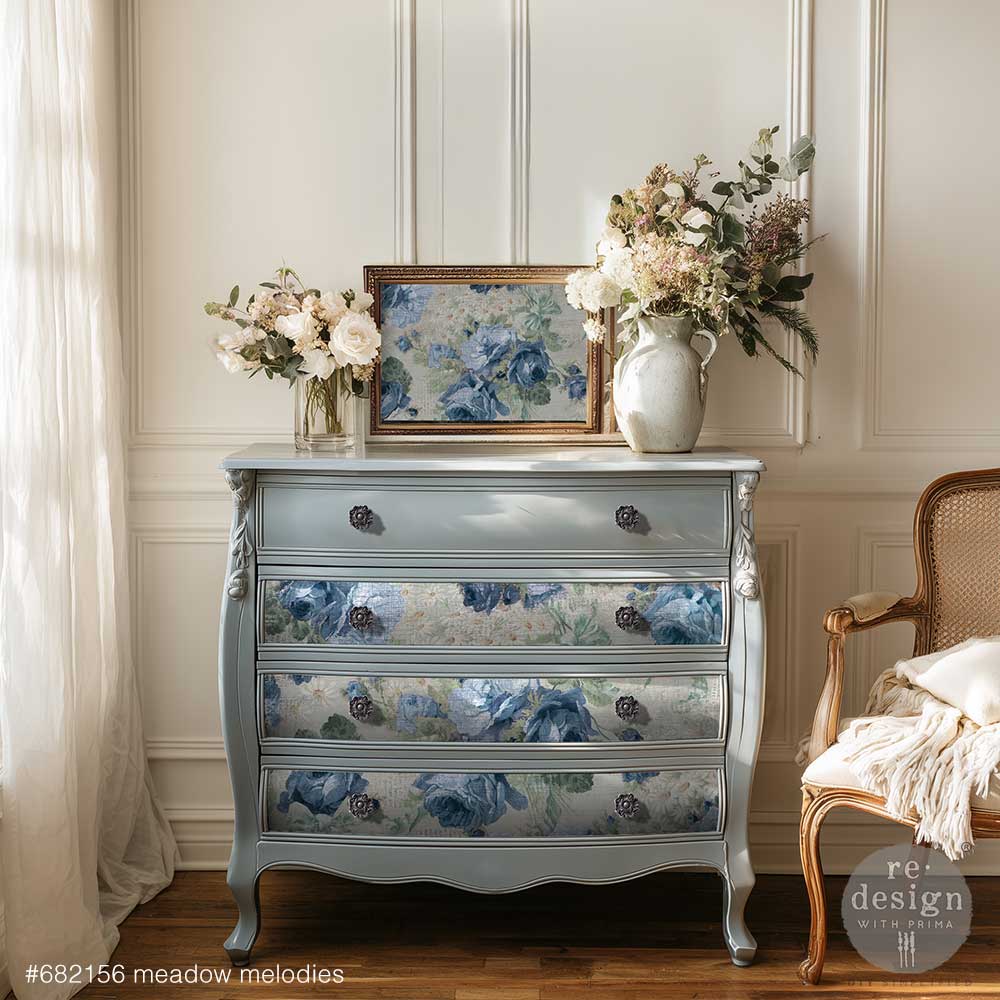 Papel decoupage Meadow Melodies de Re-Design with Prima aplicado en cómoda bombeada azul grisáceo con tiradores negros - rosas azules en cajones centrales, estilo francés clásico restaurado