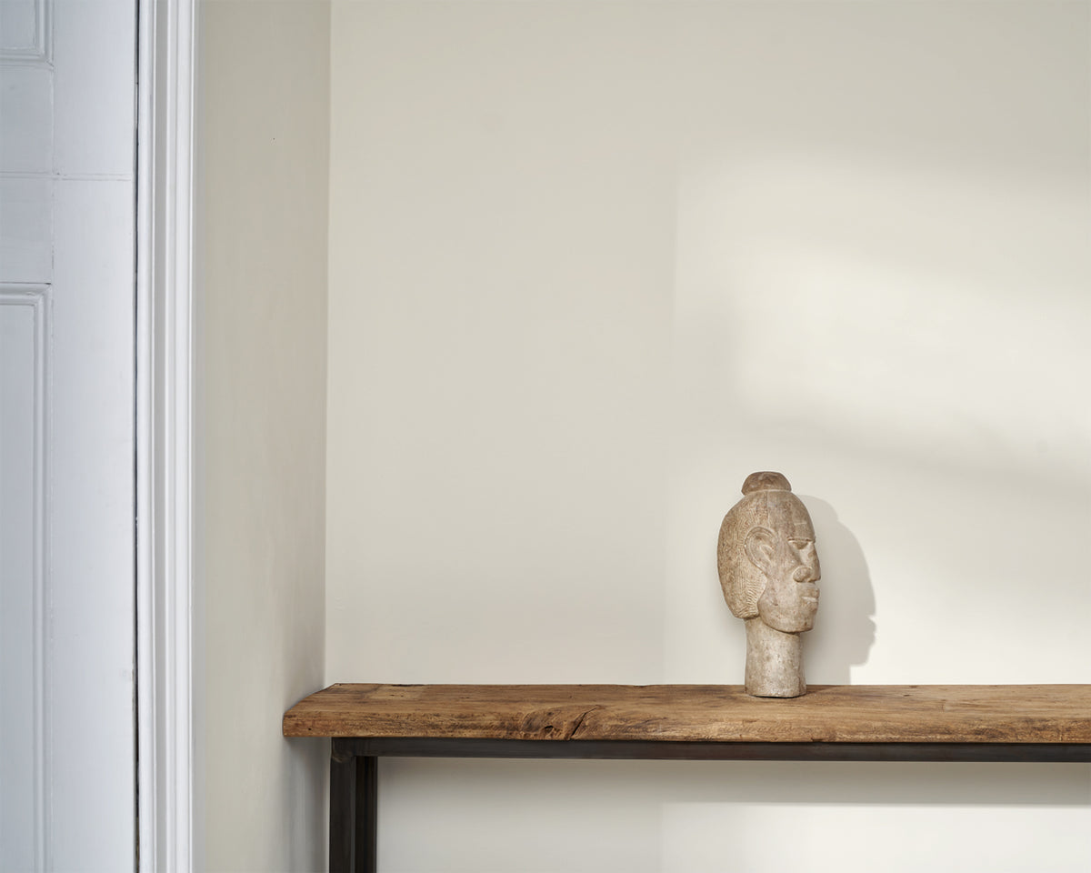 Detalle decorativo con escultura de cabeza sobre pared pintada en Wall Paint Pure de Annie Sloan