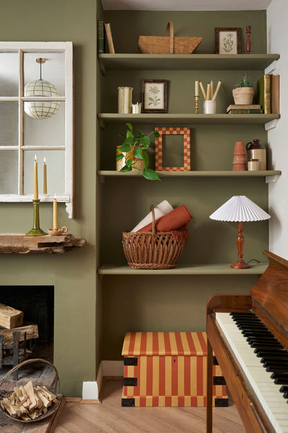 Salón acogedor con paredes pintadas en Wall Paint Olive de Annie Sloan